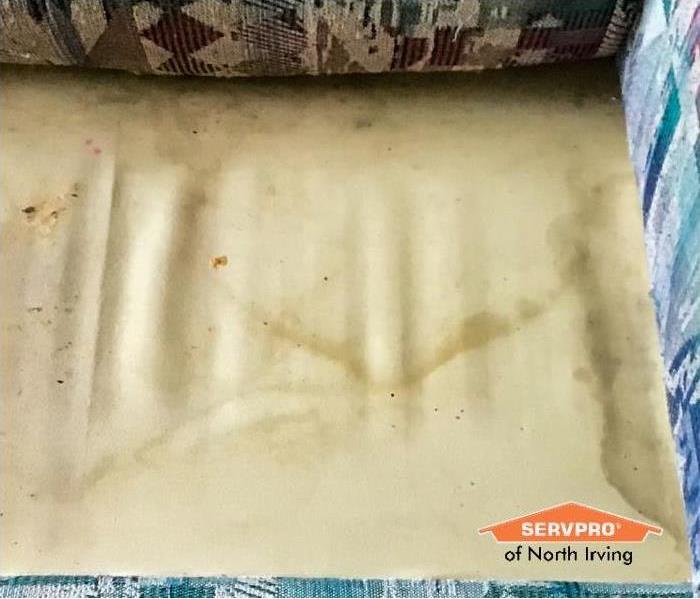 couch with brown stains on it