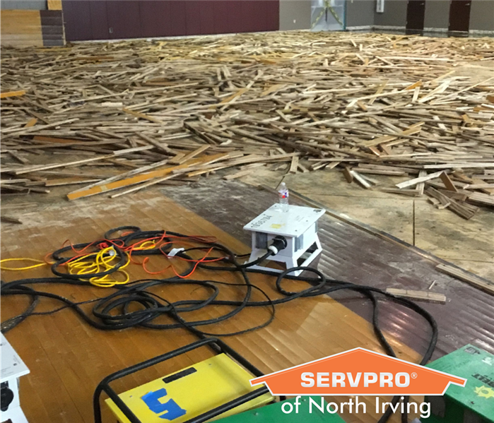 ruined school basketball court after commercial water damage
