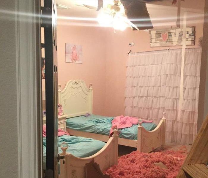 Bedroom with debris after ceiling collapse 