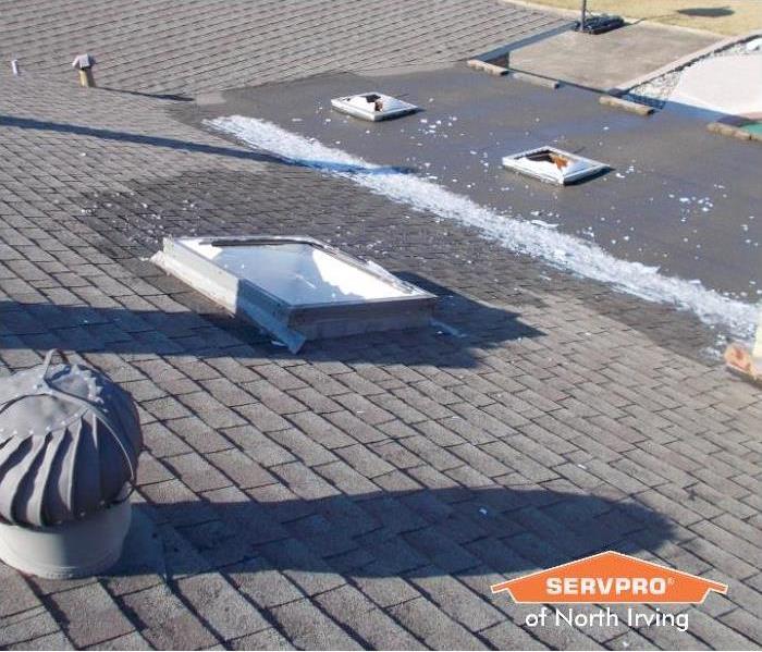 rooftop with skylights broken after a hail storm